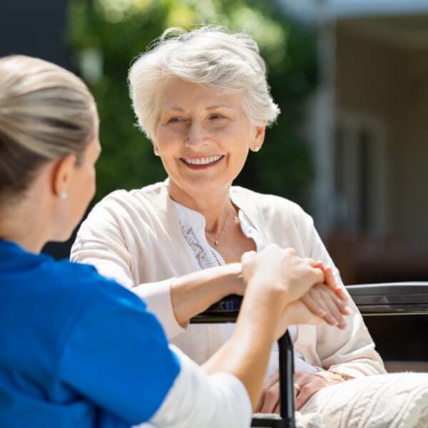 Older woman receiving personalised in-home support from a care professional